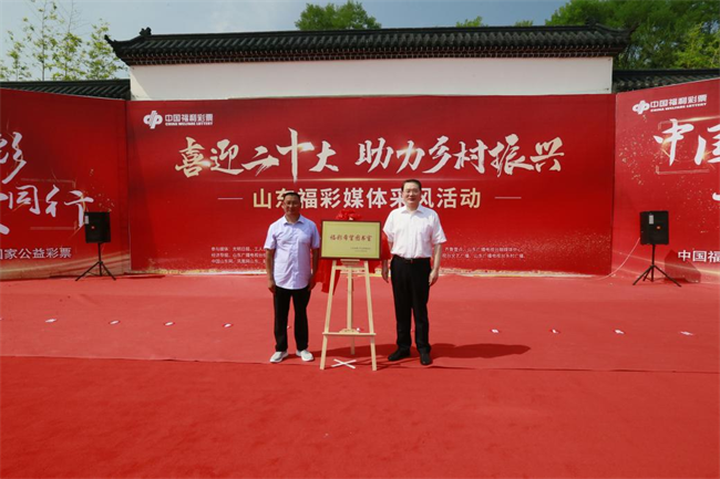 省福彩中心主任王偉與沂源縣徐家莊中心學校校長傅懷佳共同為“福彩希望圖書室”揭牌。 山東省福彩供圖）