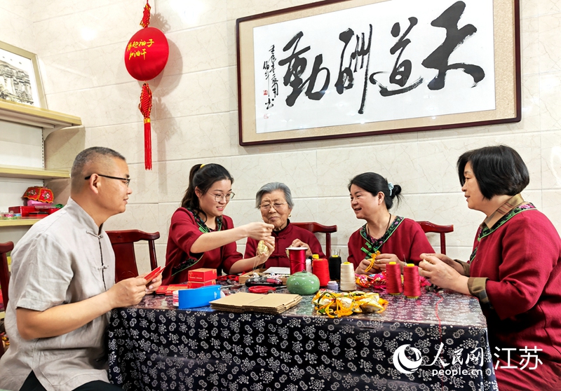 王秀英老人指導(dǎo)孫女制作香包。人民網(wǎng) 閆峰攝